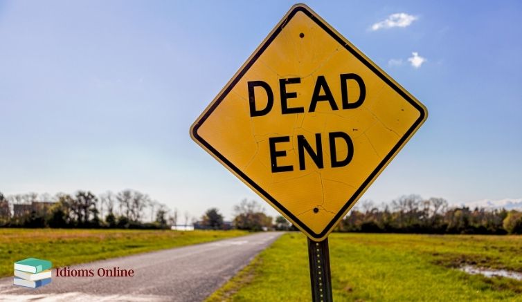 "Dead end" sign to illustrate a typical use of the word "dead" in an English idiom to mean final, absolute, or complete. 
